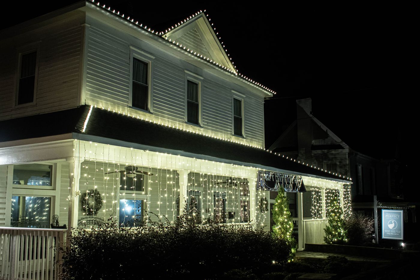 Two rooflines and a wrapped porch, read from the street